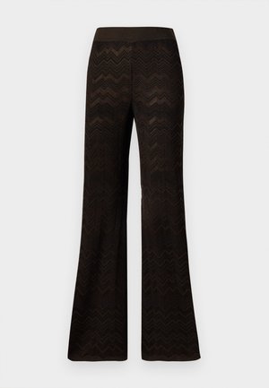 Bredde sorte bukser med et zigzag-strikket mønster og elastisk talje, vist mod en ensfarvet hvid baggrund.