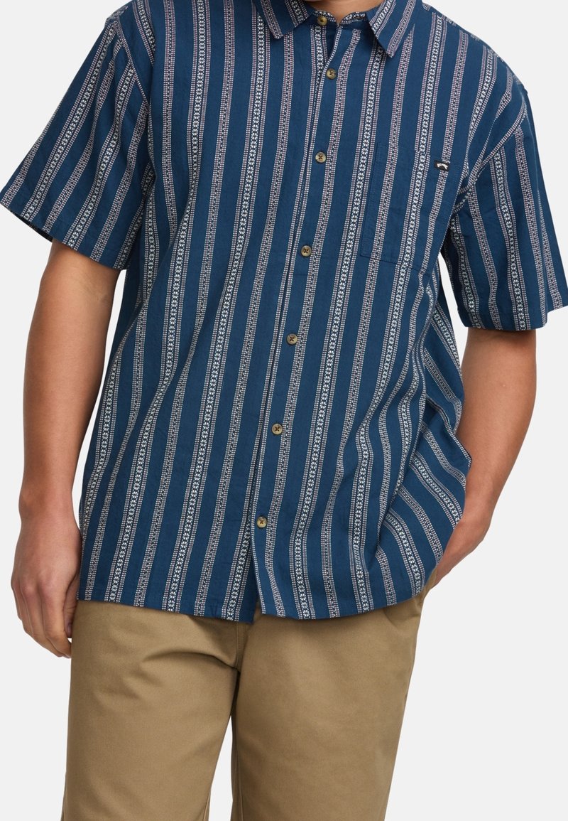 Short-sleeve shirt in navy blue, featuring white vertical stripes with a subtle pattern, button-up front, and one chest pocket.