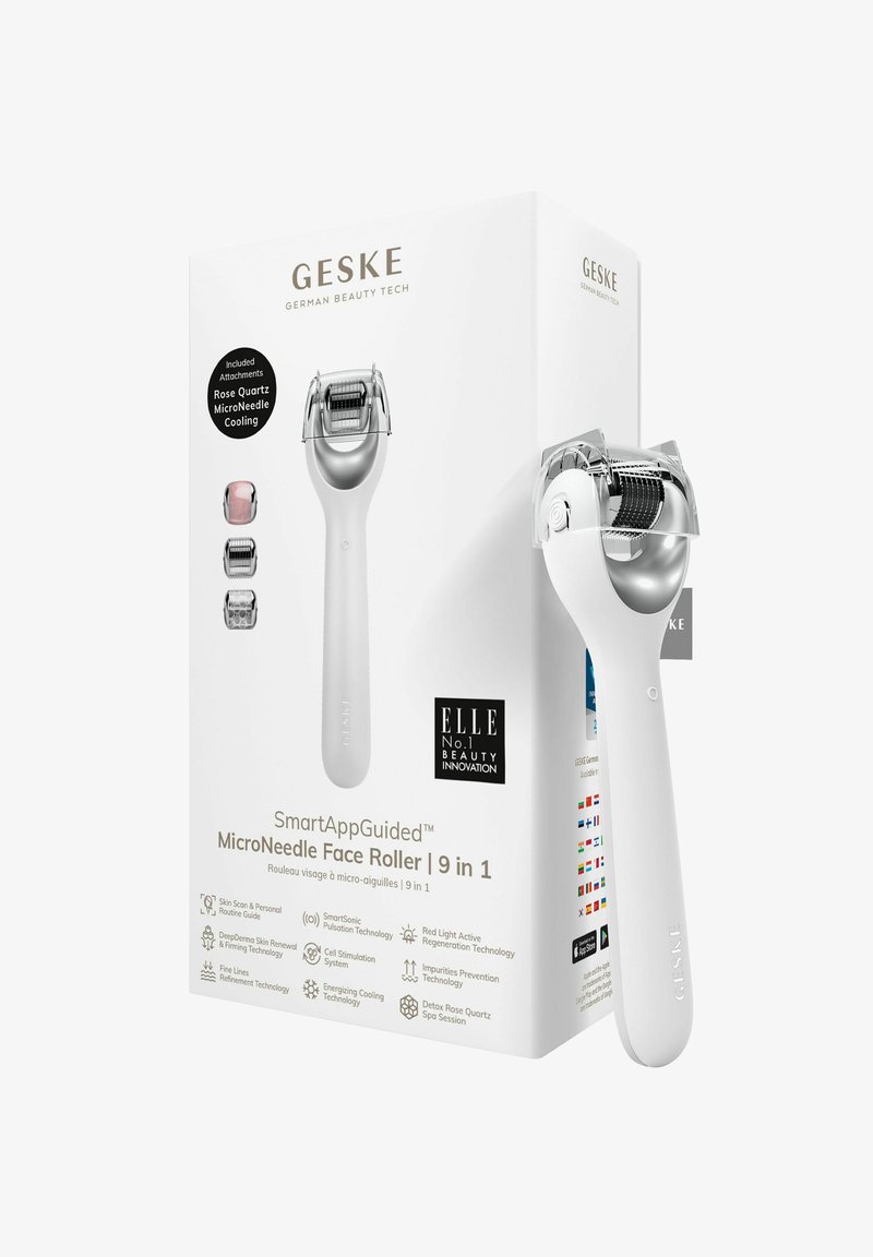 Micronaalden Face Roller met een witte handgreep en een zilveren kop, verpakt in een witte doos met zwarte en zilveren tekst, inclusief opzetstukken.