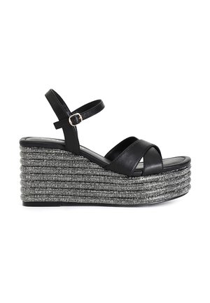 Sandali wedge neri in pelle con cinturini incrociati, caratterizzati da un design a corda argentata sulla piattaforma e una fibbia sul cinturino alla caviglia.