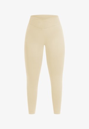 Beige leggings med en bred, krydset linning, tætsiddende design og glat, elastisk stof. Ingen synlige mønstre eller hardware-detaljer.