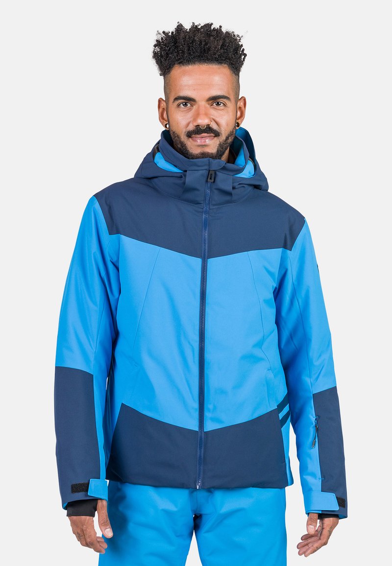 Blaue und marinefarbene, farblich abgesetzte Skijacke mit Kapuze, Reißverschluss, verstellbaren Manschetten und einer Seitentasche. Weiches, wasserabweisendes Material.