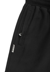 UNFAIR ATHLETICS CURVED - Tréningruha alsók - black