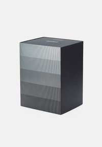 Black packaging box with vertical silver stripes, flat top, embossed numbers on the side, minimalistic design, smooth texture.