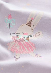 Light purple fabric features a cartoon bunny in a pink dress and wings, holding a wand with a star. The bunny has a cone-shaped hat.