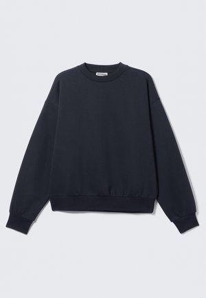 Felpa blu navy scuro in misto cotone, con scollo rotondo, spalle scese, polsini a costine e orlo elasticizzato. Design minimalista.