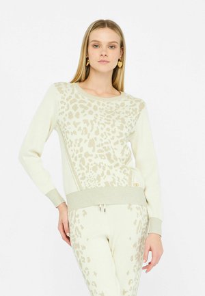 Maglione lavorato a maglia beige con design a motivo leopardo in una tonalità più chiara, con polsini a coste e scollatura rotonda. Presenti dettagli testurizzati.
