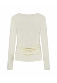 Licht beige lange mouw top met een ronde halslijn en geplooide details langs de zijkanten. Gemaakt van gladde, rekbare stof.