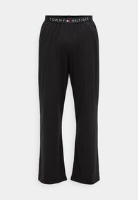 Pantalons lounge noirs en tissu doux, dotés d'une large taille avec le logo "TOMMY HILFIGER". Design droit, coupe ample.