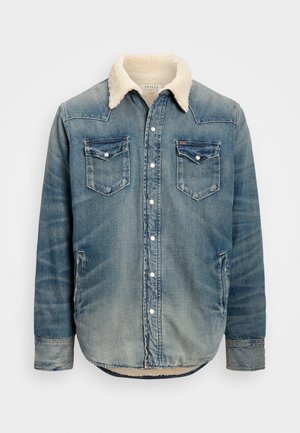 Jeansjacke mit heller Blaufärbung, kontrastierenden Nähten, Lammfellkragen, zwei Brusttaschen und Knopfverschluss.