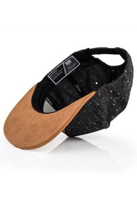 Black and suede cap with a tan visor. The cap features a textured black fabric body and a perforated tan leather front. Interior label visible.
