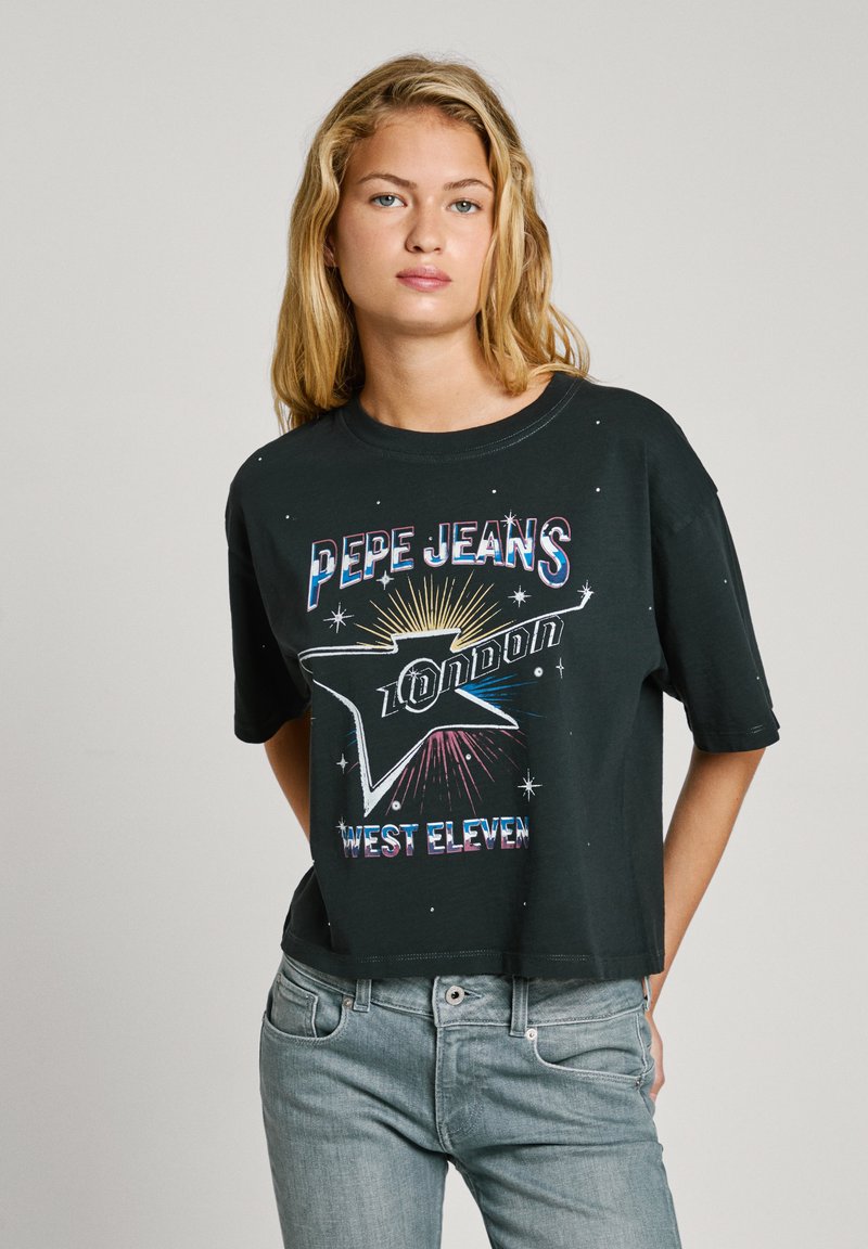 Black cropped t-shirt made of cotton featuring multicolored printed text "PEPE JEANS LONDON" and graphics, with a relaxed fit and short sleeves.