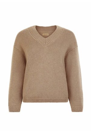 Beżowy sweter z dzianiny z dekoltem w serek, luźnym krojem oraz ściągaczami na rękawach i dole. Miękka faktura, średnia grubość i prosty design.