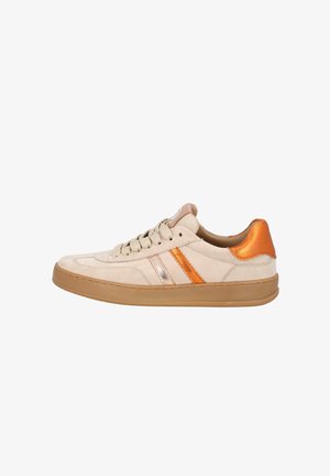 Beige suede sneaker with orange and metallic stripe accents, flat laces, rubber sole, and a smooth texture. Rounded toe and low-top design.