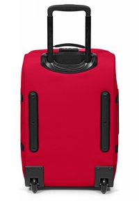 Red wheeled suitcase with a smooth fabric exterior, retractable handle, and black accents. Features sturdy wheels for easy mobility.