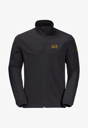 Veste d'extérieur noire zippée avec col montant, poignets élastiques, deux poches latérales et logo jaune « Jack Wolfskin » sur la poitrine et la manche gauche.