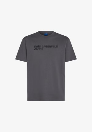 Szürke pamut póló, rövid ujjakkal, kerek nyakkivágással, és vastag fekete betűkkel a mellkason: "KARL LAGERFELD JEANS".