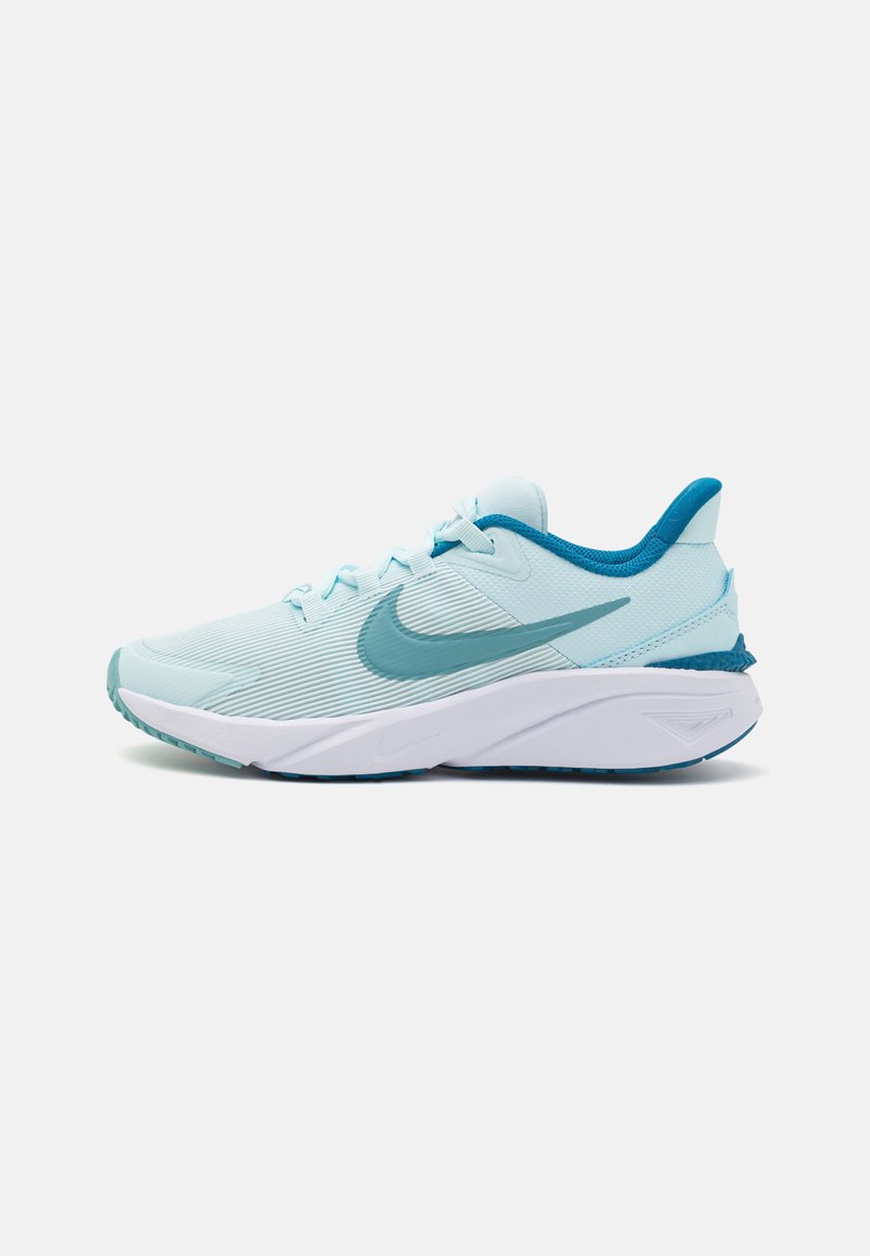 Light blue athletic shoe with textured upper, turquoise accents, cushioned sole, and white midsole. Features a prominent logo on the side.