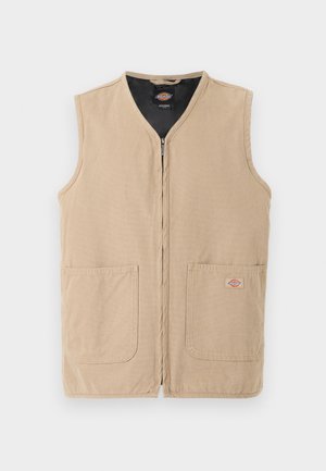 Μπεζ αμάνικο γιλέκο με φερμουάρ μπροστά, δύο μεγάλες μπροστινές τσέπες και μικρό λογότυπο στην δεξιά τσέπη, σε απλό φωτεινό φόντο.