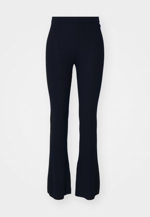 Navy ribbed flared pants with a fitted waistband. Made from a soft, textured material, featuring a wide flared bottom for a relaxed fit.
