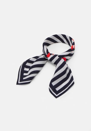Silk scarf with navy blue and white diagonal stripes, tied in a loose knot, featuring small red accents on the edges.
