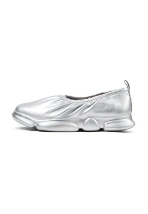 Silver slip-on shoe with a gathered, textured upper and a cushioned outsole featuring rounded, elongated pods. Lightweight design enhances flexibility.