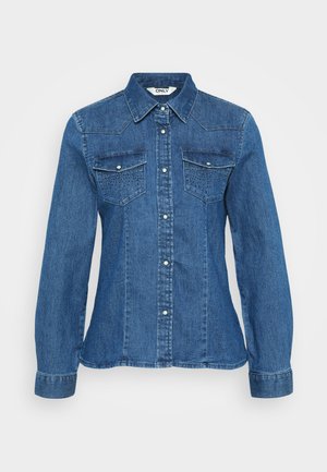 Camisa de ganga com fecho frontal por botões, colarinho pontiagudo e dois bolsos no peito. Apresenta um padrão texturizado com costura decorativa numa cor azul média.