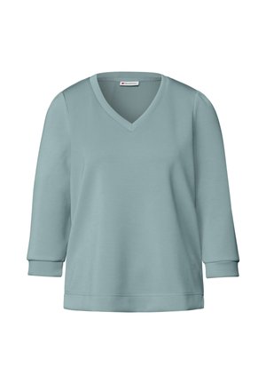 Ljusblå V-hals sweatshirt med trekvartslånga ärmar, mjuk textur och avslappnad passform. Enkel design utan synliga mönster eller detaljer.