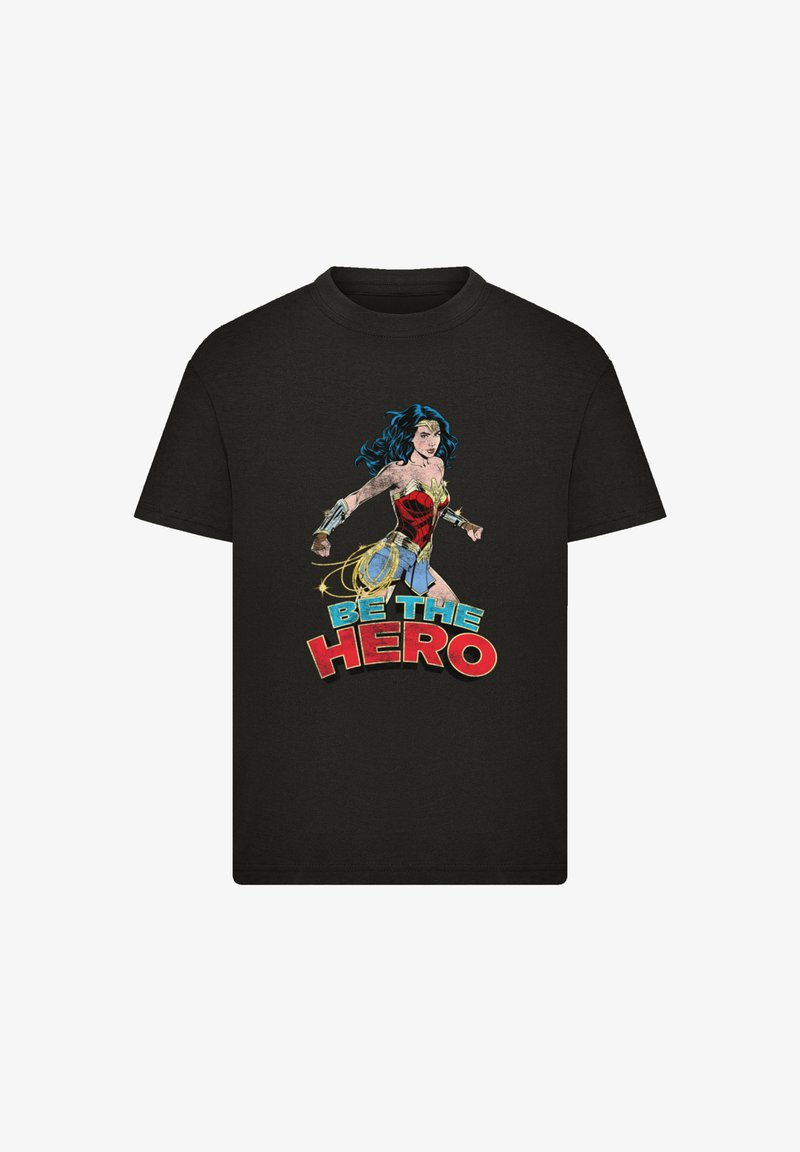 Black t-shirt featuring a graphic of a female superhero, with colorful comic-style text “BE THE HERO” in red and blue accents.