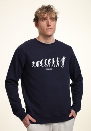 Marineblå sweatshirt lavet af bomuld, med et hvidt evolutionært grafisk motiv på brystet samt ribbede manchetter og kant for struktur.