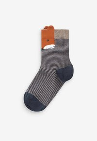 Calze a righe con un design di volpe al polsino, realizzate in tessuto morbido. I colori includono blu navy, beige e arancione, con un volto dettagliato.
