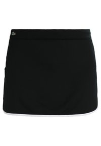 Černá sukně s hladkým povrchem, zdobená bílým akcentem na lemu a malým zeleným logem na pase.