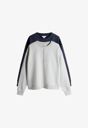 Dve henley mikiny s výstrihom crewneck a dlhými rukávmi, jedna svetlosivá vpredu a jedna tmavomodrá vzadu, obe s gombíkovými lištami a rebrovanými manžetami.