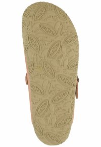 Light brown flat sandal sole with a textured cream rubber bottom, featuring an embossed logo and a smooth, rounded design.