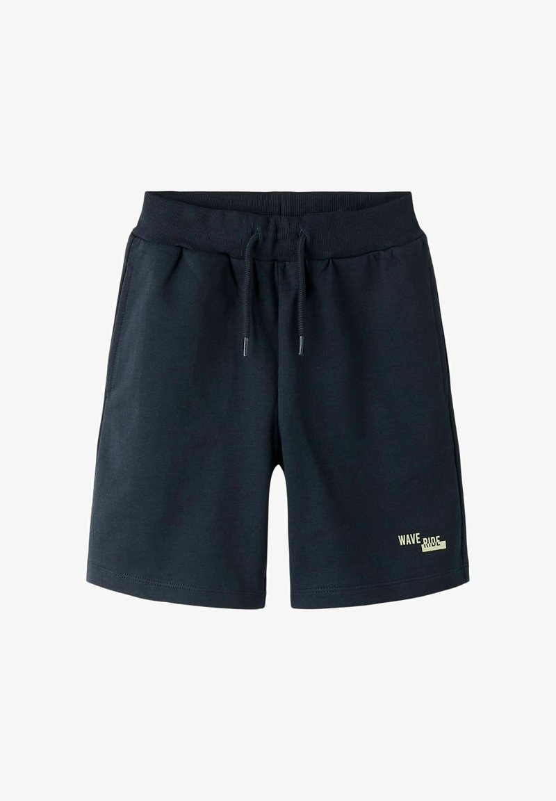 Shorts en coton bleu marine avec ceinture élastique et cordon, avec le texte « WAVE RIDE » sur le bas de la jambe gauche.