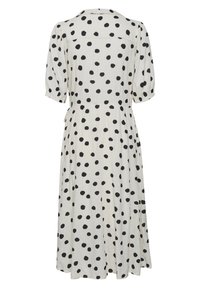 Vestido de lunares en tela blanca con puntos negros. Cuenta con mangas cortas abullonadas, un escote con cuello y una forma fluida en A.