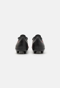 Black soccer cleats with a textured leather surface, featuring a streamlined design, sturdy heel, and molded studs for traction.