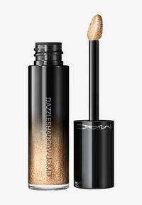 Czarna tube z MAC Dazzleshadow Liquid z złotym brokatowym cieniem do powiek oraz aplikatorem obok.