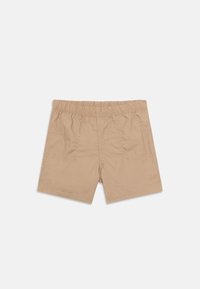 Beige shortsit elastisella vyötäröllä. Kevyestä kankaasta valmistettu, sileäpintainen ja yksinkertainen muotoilu ilman taskuja.
