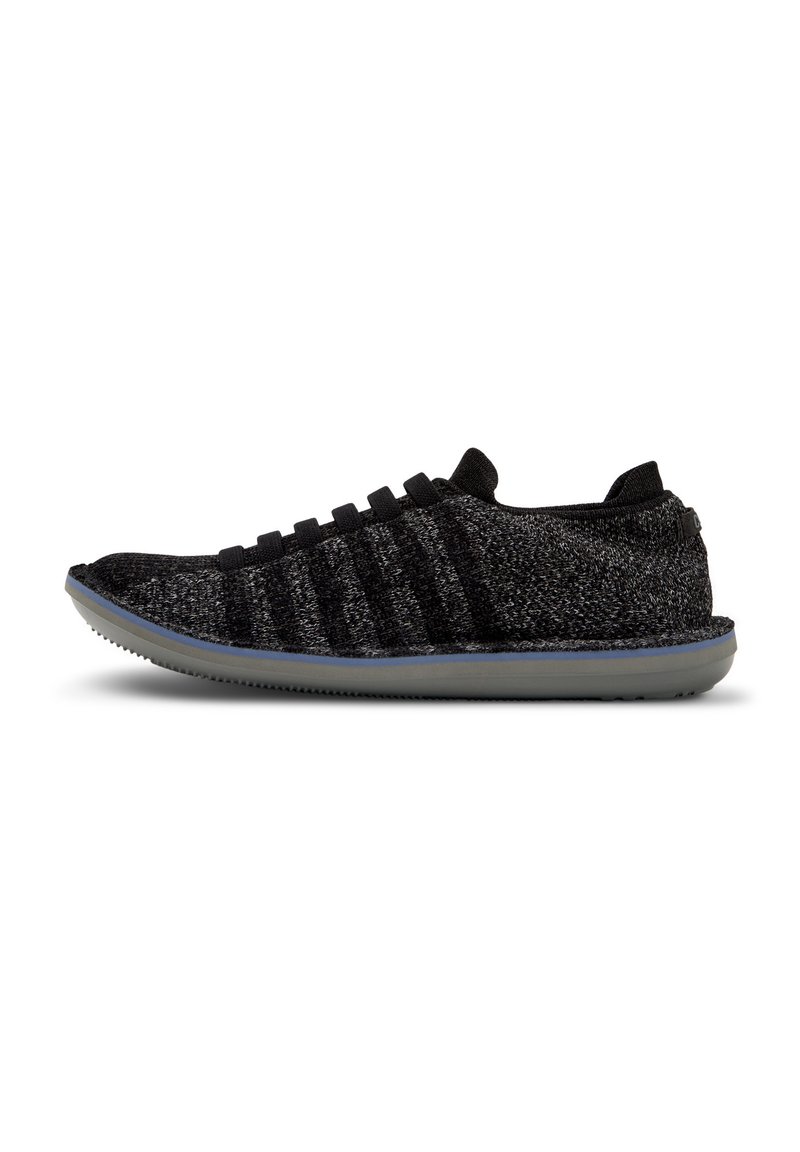 Black and grey knit sneaker with a textured upper, featuring elastic laces and a flexible, light grey rubber sole.