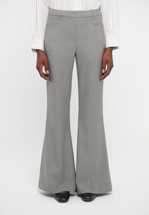 Gray pinstriped flared trousers with a tailored fit. Features side pockets and a smooth fabric texture. Worn with black shoes.