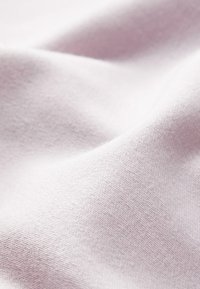 Zachte, lichte stof in zachtroze, met een gladde textuur en een subtiel weefpatroon, ideaal voor kleding of textiel voor in huis.