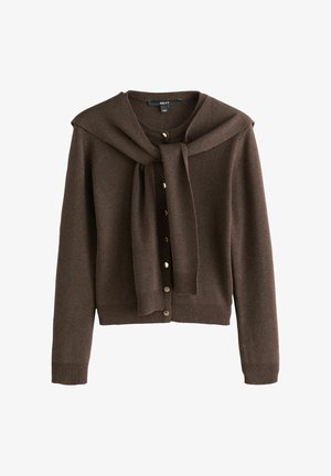 Gilet marron avec un détail à nouer au cou, fabriqué en matériau doux. Présente une fermeture à bouton sur le devant et des poignets et un bas côtelés.