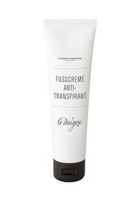 Weißer Tubus mit schwarzer Kappe, beschriftet mit "Fusscreme Anti-Transpirant" und "le Duigou Cosmétiqu", verfügt über einfachen schwarzen Text und ein minimales Design.