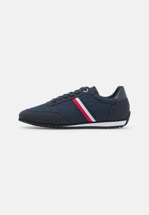Sneakers blu navy con tomaia in tessuto e sintetico, strisce bianche e rosse, chiusura con lacci e suola in gomma testurizzata con battistrada triangolare.