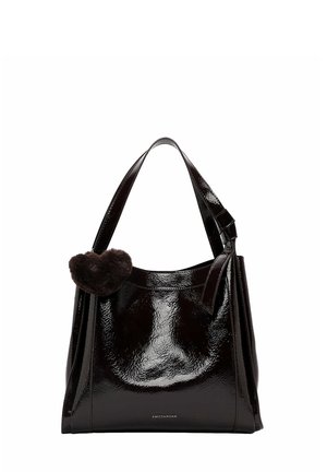 Shiny black patent leather handbag with wide handles and a small dark brown fuzzy heart keychain attached to one handle.