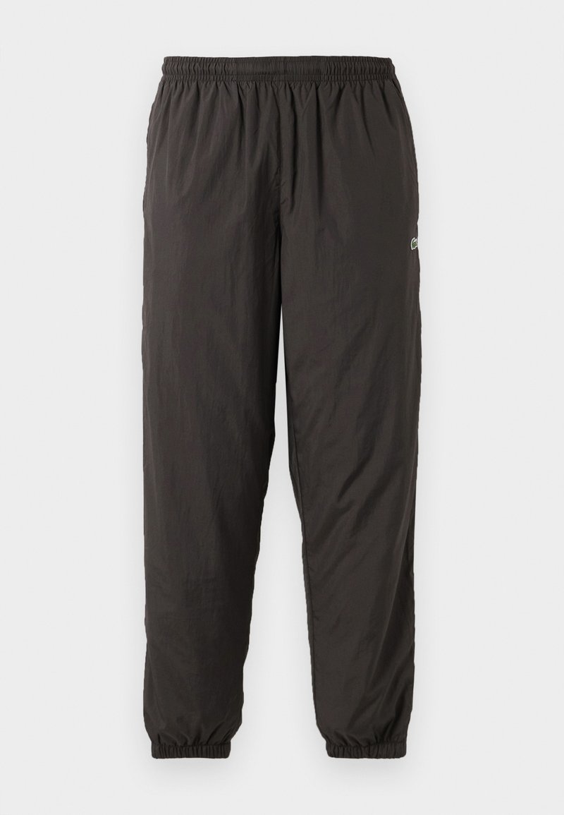 Svarta, lätta, elastiska midjebyxor med lös passform. Har elastiska muddarna och en diskret logotyp på sidan. Slät textur.