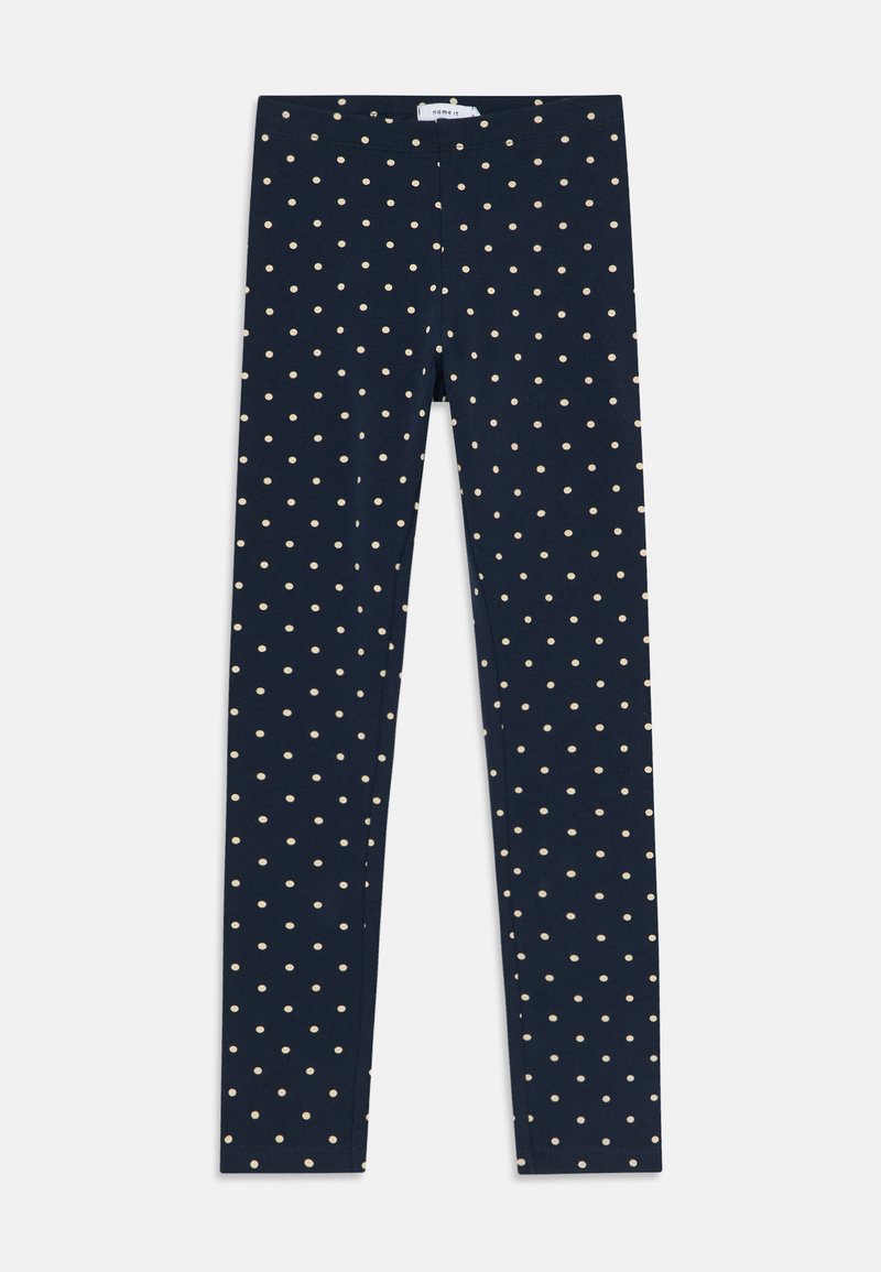Sötétkék leggings, testhezálló szabással, világos bézs pöttyökkel az egész felületen. Puha, rugalmas anyagból készült.