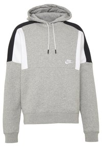 Harmaa huppari, jossa on mustat ja valkoiset olkapaneelit, kiristettävä huppu ja pieni valkoinen Nike-logo rinnassa. Pehmeä kankaan rakenne.