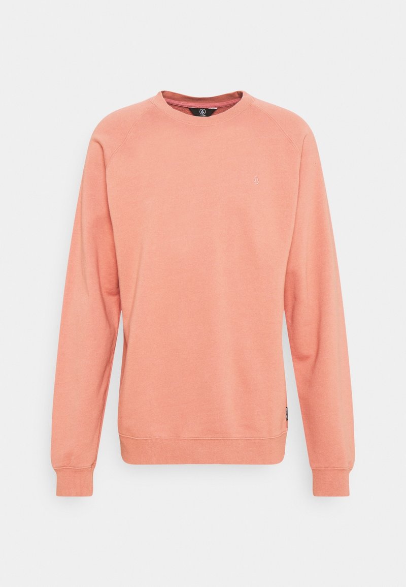 Lyserød koral sweatshirts lavet af blød bomuldsblanding med lange raglanærmer og en ribbet halsudskæring. Har et lille logo på brystet.